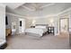 Spacious main bedroom featuring tray ceilings, plush carpet, and ensuite bathroom access at 6305 Deerwoods Trl, Alpharetta, GA 30005