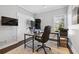 Practical office space featuring a multi-monitor setup, neutral walls, and natural light at 6305 Deerwoods Trl, Alpharetta, GA 30005