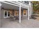 Charming covered patio with stone flooring and an outdoor dining set at 6305 Deerwoods Trl, Alpharetta, GA 30005