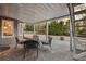 Cozy covered patio with stone flooring and an outdoor dining set at 6305 Deerwoods Trl, Alpharetta, GA 30005