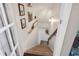 Bright staircase features neutral carpet, white walls, and decorative shelving with lovely decor at 6305 Deerwoods Trl, Alpharetta, GA 30005