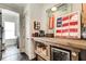 Stylish bar area with rustic wood countertop, wine refrigerator, and decorative accents at 164 Inwood Walk, Woodstock, GA 30188