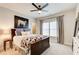 This bedroom has a ceiling fan, a large window with curtains, and dark wooden furniture at 164 Inwood Walk, Woodstock, GA 30188