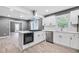 Well-lit kitchen featuring an island with an oven and cooktop, stainless steel dishwasher, and modern cabinetry at 1788 Rosewood Rd, Decatur, GA 30032