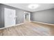 Bright living room with gray walls, modern light fixture, and light-colored hardwood floors at 1788 Rosewood Rd, Decatur, GA 30032