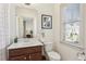 Bright bathroom with a large mirror, white vanity, and shower and toilet at 214 Avery Ne St, Marietta, GA 30060