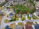 Aerial view of neighborhood and homes in a suburban setting with mature trees at 2557 Tolliver Dr, Ellenwood, GA 30294