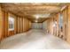 Unfinished basement with concrete floor, exposed wall studs, and window ready for customization at 2557 Tolliver Dr, Ellenwood, GA 30294