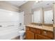 Bathroom featuring a shower-tub combo, granite countertop vanity, and tile flooring at 2557 Tolliver Dr, Ellenwood, GA 30294