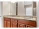Bathroom showcasing a double vanity with granite countertops, mirrors, and wooden cabinetry at 2557 Tolliver Dr, Ellenwood, GA 30294
