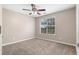 Bedroom featuring a window view, neutral walls, plush carpeting, and a modern ceiling fan at 2557 Tolliver Dr, Ellenwood, GA 30294