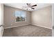 Bedroom featuring a window view, neutral walls, plush carpeting, and a modern ceiling fan at 2557 Tolliver Dr, Ellenwood, GA 30294