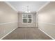 Inviting dining room with carpet, a chandelier, and large window, perfect for entertaining at 2557 Tolliver Dr, Ellenwood, GA 30294