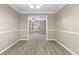 Well-lit dining room showcasing carpet and an open archway, creating a welcoming atmosphere at 2557 Tolliver Dr, Ellenwood, GA 30294