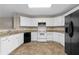 Spacious kitchen with white cabinets, granite countertops, and black appliances, ready for cooking at 2557 Tolliver Dr, Ellenwood, GA 30294