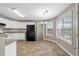 Open concept kitchen with dining area featuring modern chandelier and view to the outdoors at 2557 Tolliver Dr, Ellenwood, GA 30294