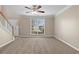 Bright living room featuring neutral tones, large window and carpet, creating a serene space at 2557 Tolliver Dr, Ellenwood, GA 30294