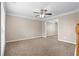 Neutral living room with carpet, large window and ceiling fan, offering a cozy atmosphere at 2557 Tolliver Dr, Ellenwood, GA 30294