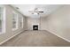 Spacious living room with fireplace, neutral walls, and multiple windows at 2557 Tolliver Dr, Ellenwood, GA 30294
