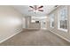 Inviting living room with connection to kitchen, neutral carpet and large windows at 2557 Tolliver Dr, Ellenwood, GA 30294