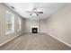 Cozy living room with a fireplace, neutral carpet, and large windows at 2557 Tolliver Dr, Ellenwood, GA 30294