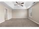 A spacious main bedroom features neutral walls, plush carpeting, and a modern ceiling fan at 2557 Tolliver Dr, Ellenwood, GA 30294