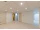 Basement features white walls, neutral carpet, recessed lights, and multiple interior doors at 5594 Mountain View Pass, Stone Mountain, GA 30087