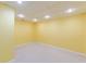 Bright basement room featuring recessed lighting, neutral carpet, and yellow painted walls at 5594 Mountain View Pass, Stone Mountain, GA 30087