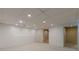 Basement with neutral carpet, white walls, recessed lights, and multiple interior doors at 5594 Mountain View Pass, Stone Mountain, GA 30087