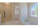 Bathroom showcases a shower stall and a soaking tub beneath an arched window at 5594 Mountain View Pass, Stone Mountain, GA 30087