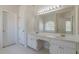 Bathroom with double sinks, vanity, and a large mirror illuminated by Hollywood-style lighting at 5594 Mountain View Pass, Stone Mountain, GA 30087