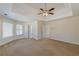 Spacious bedroom with tray ceilings, large windows, and neutral carpeting offering a peaceful retreat at 5594 Mountain View Pass, Stone Mountain, GA 30087
