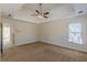 Spacious bedroom with a tray ceiling and a ceiling fan, complemented by a large window at 5594 Mountain View Pass, Stone Mountain, GA 30087