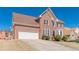 View of a brick home with a large front lawn and attached two-car garage on a sunny day at 5594 Mountain View Pass, Stone Mountain, GA 30087