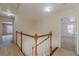 Upstairs hallway with wood railings that offers a view of the bedrooms at 5594 Mountain View Pass, Stone Mountain, GA 30087