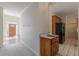 Hallway with wood cabinets and tiled flooring leading to the front door at 5594 Mountain View Pass, Stone Mountain, GA 30087