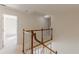 Upstairs hallway featuring wood railings and a view of the doorway ahead at 5594 Mountain View Pass, Stone Mountain, GA 30087