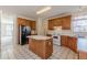 Bright kitchen featuring wood cabinets, center island, and modern appliances at 5594 Mountain View Pass, Stone Mountain, GA 30087