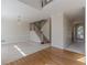 Bright living room featuring a staircase, chandelier, and a combination of hardwood and carpeted floors at 5594 Mountain View Pass, Stone Mountain, GA 30087