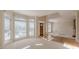 Bright living room featuring large bay windows, hardwood floors, and view to front entryway at 5594 Mountain View Pass, Stone Mountain, GA 30087