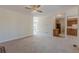 Open living space with kitchen access, ceiling fan, and large windows, creating a welcoming atmosphere at 5594 Mountain View Pass, Stone Mountain, GA 30087