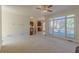 Open concept living area connects to the kitchen with a ceiling fan and large windows overlooking the deck at 5594 Mountain View Pass, Stone Mountain, GA 30087