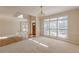 Sunlit living room with hardwood floors and large windows offering a welcoming and bright space at 5594 Mountain View Pass, Stone Mountain, GA 30087