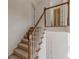 Carpeted staircase featuring white spindles and wooden railing leading to the upper level at 5594 Mountain View Pass, Stone Mountain, GA 30087