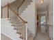 Carpeted staircase with white spindles and wood railing leading to the second floor at 5594 Mountain View Pass, Stone Mountain, GA 30087