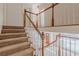 Spacious staircase with carpeted steps and wood railing, leading to the upper level and entry area at 5594 Mountain View Pass, Stone Mountain, GA 30087