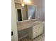 Bathroom vanity with sliding mirror, white cabinets and granite countertop at 10221 Deep Creek Pl, Union City, GA 30291