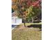 View of the home's front yard with a mature tree and well-kept lawn at 10221 Deep Creek Pl, Union City, GA 30291