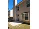 Back of beige house with stone patio at 10221 Deep Creek Pl, Union City, GA 30291