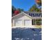Traditional two-story home featuring a two-car garage and a well-manicured lawn at 10221 Deep Creek Pl, Union City, GA 30291